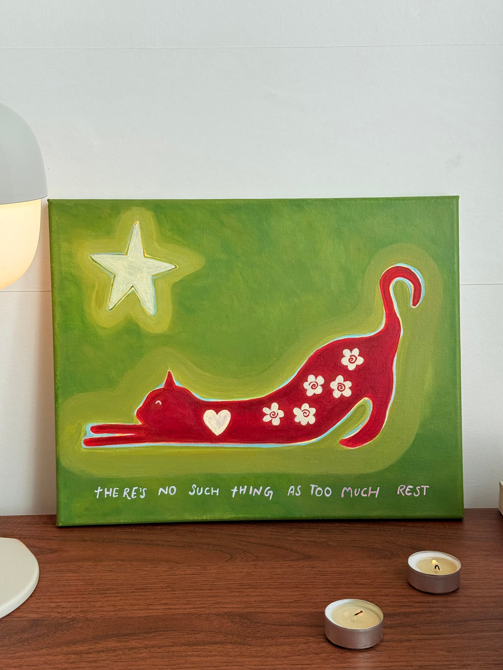 Front view of original red stretching cat artwork on an olive green canvas