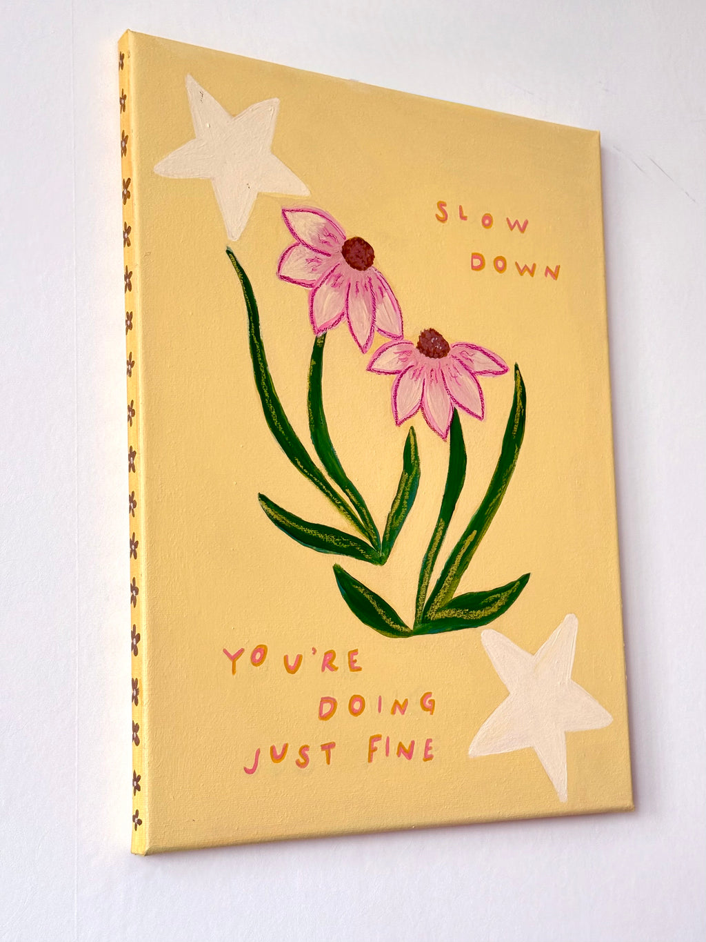 Close-up of Slow Down lettering and echinacea flowers